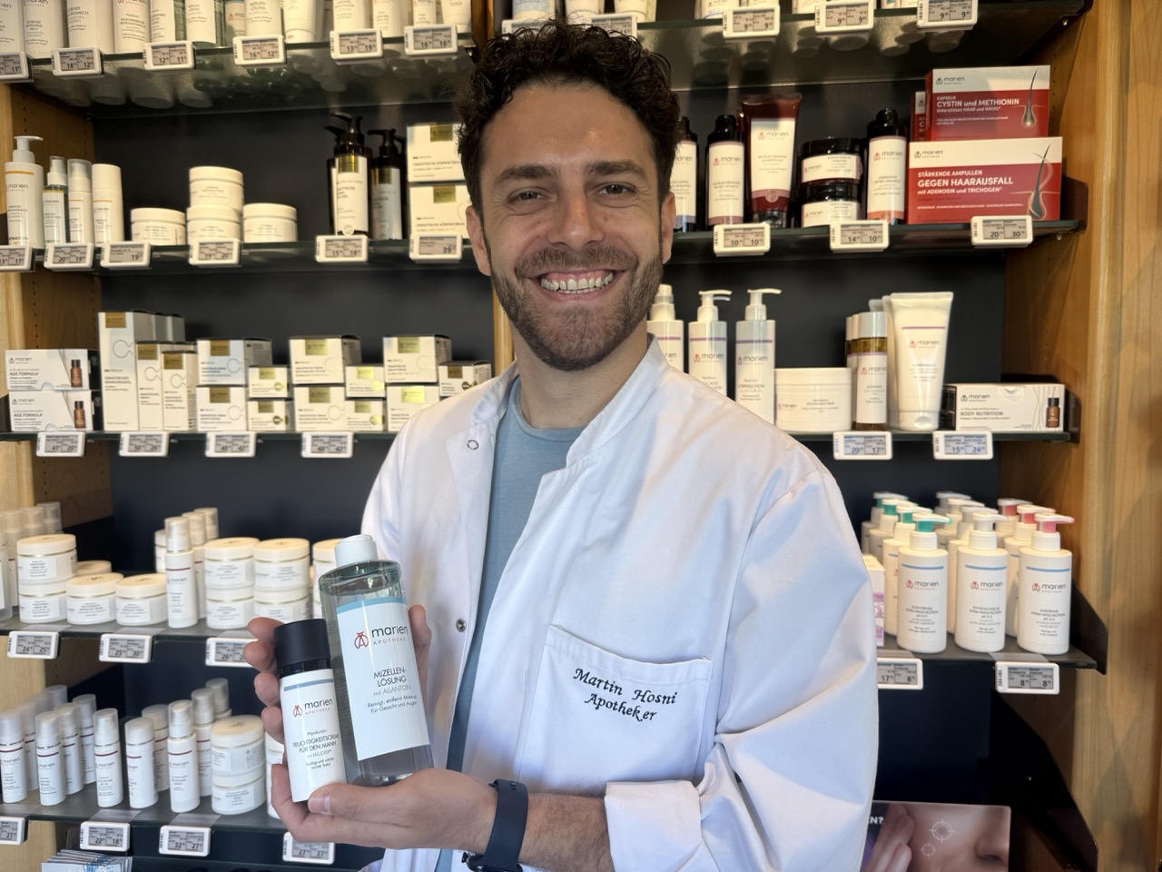 Der Apothekeninhaber mit einem Eigenmarken-Produkt in der Hand