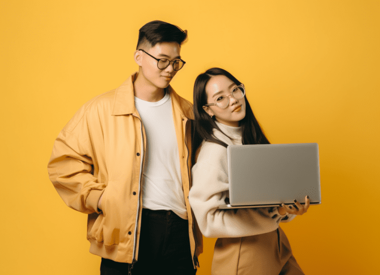 MichaG_asian_couple_holding_some_money_behind_their_laptop_on_y_589e8a91-e591-4a73-b207-c65b08d61c9d-768x557.png