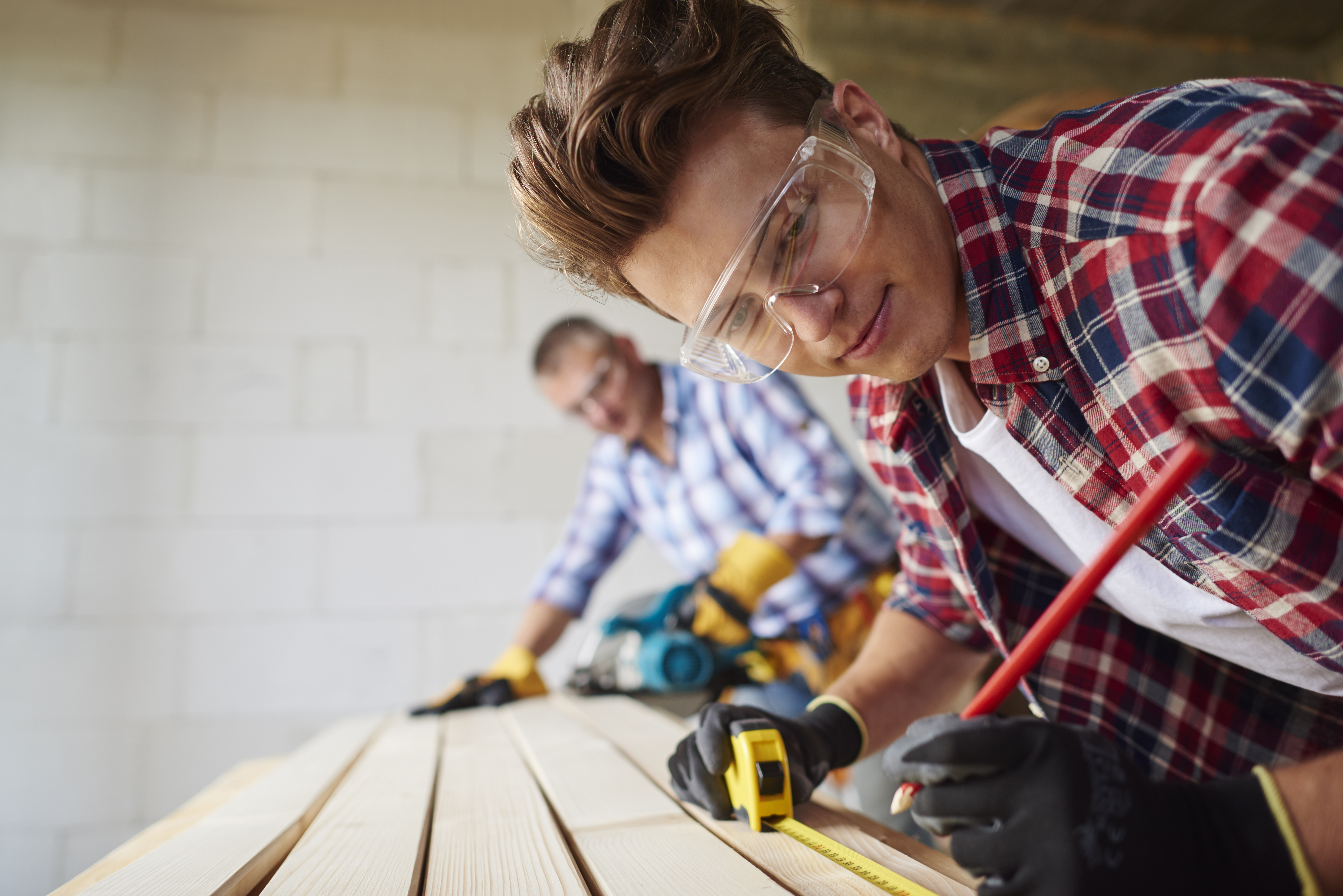 close-up-experienced-carpenter-his-younger-employee.jpg