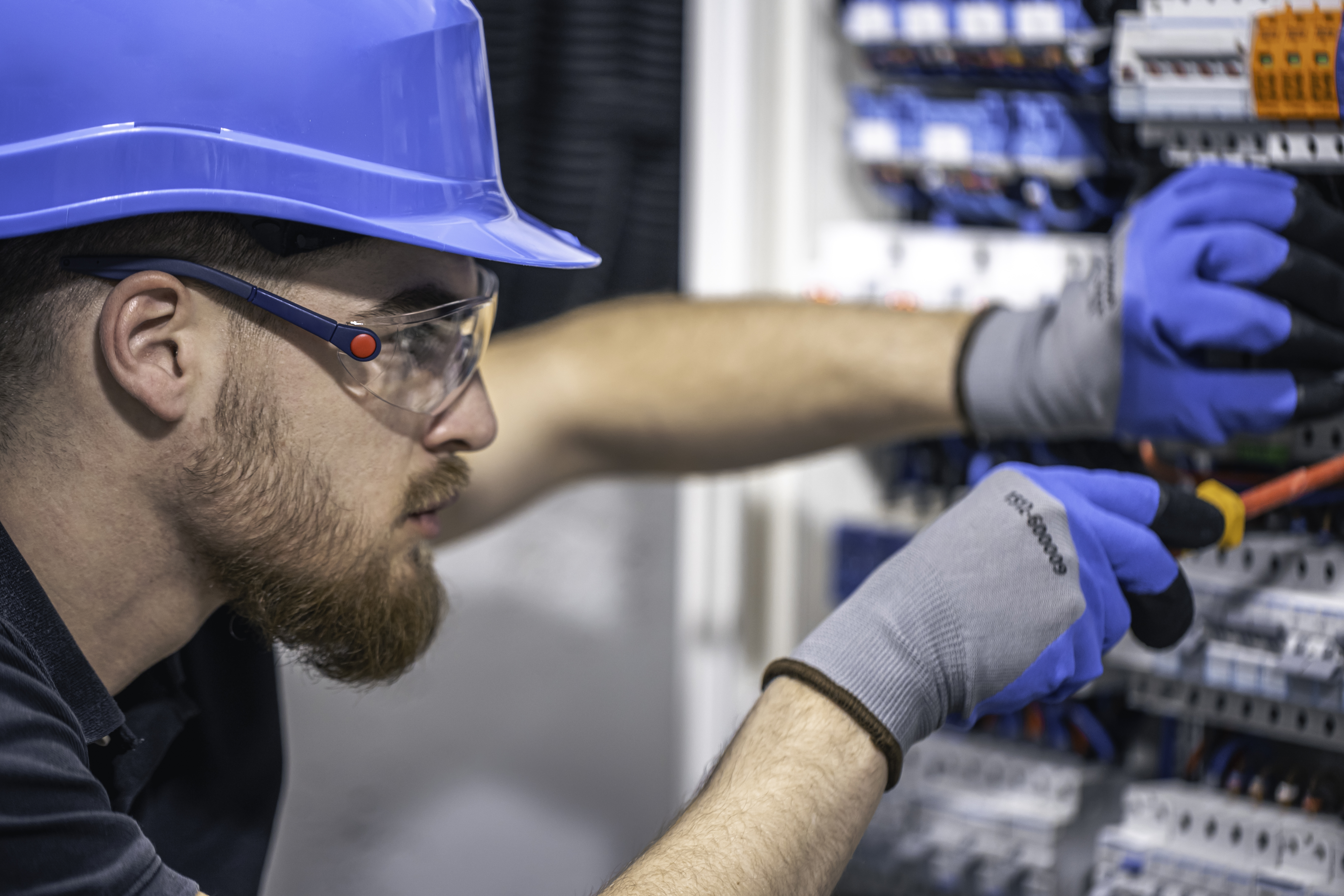 male-electrician-works-switchboard-with-electrical-connecting-cable.jpg