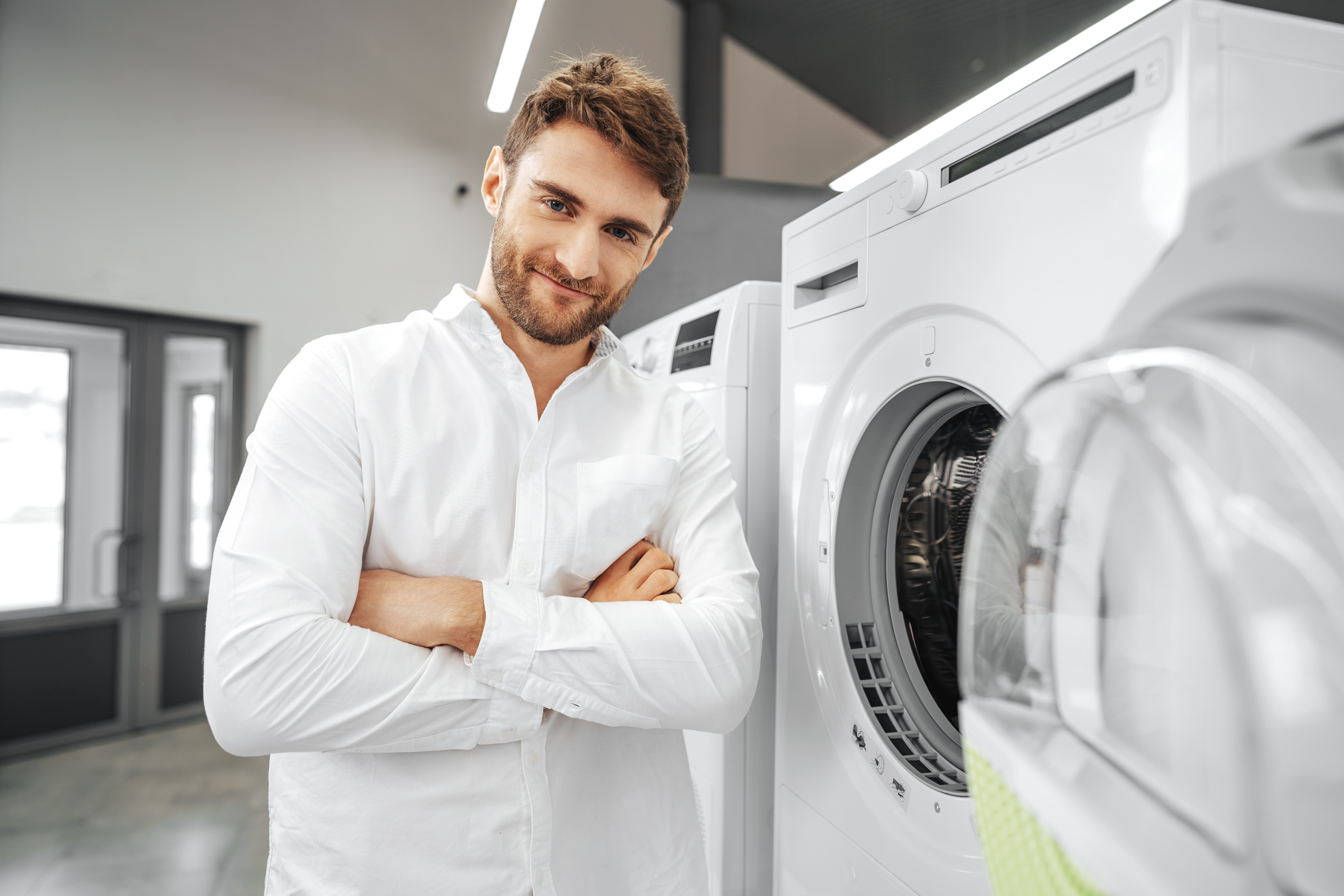 young-man-choosing-new-washing-machine-household-appliances-store.jpg