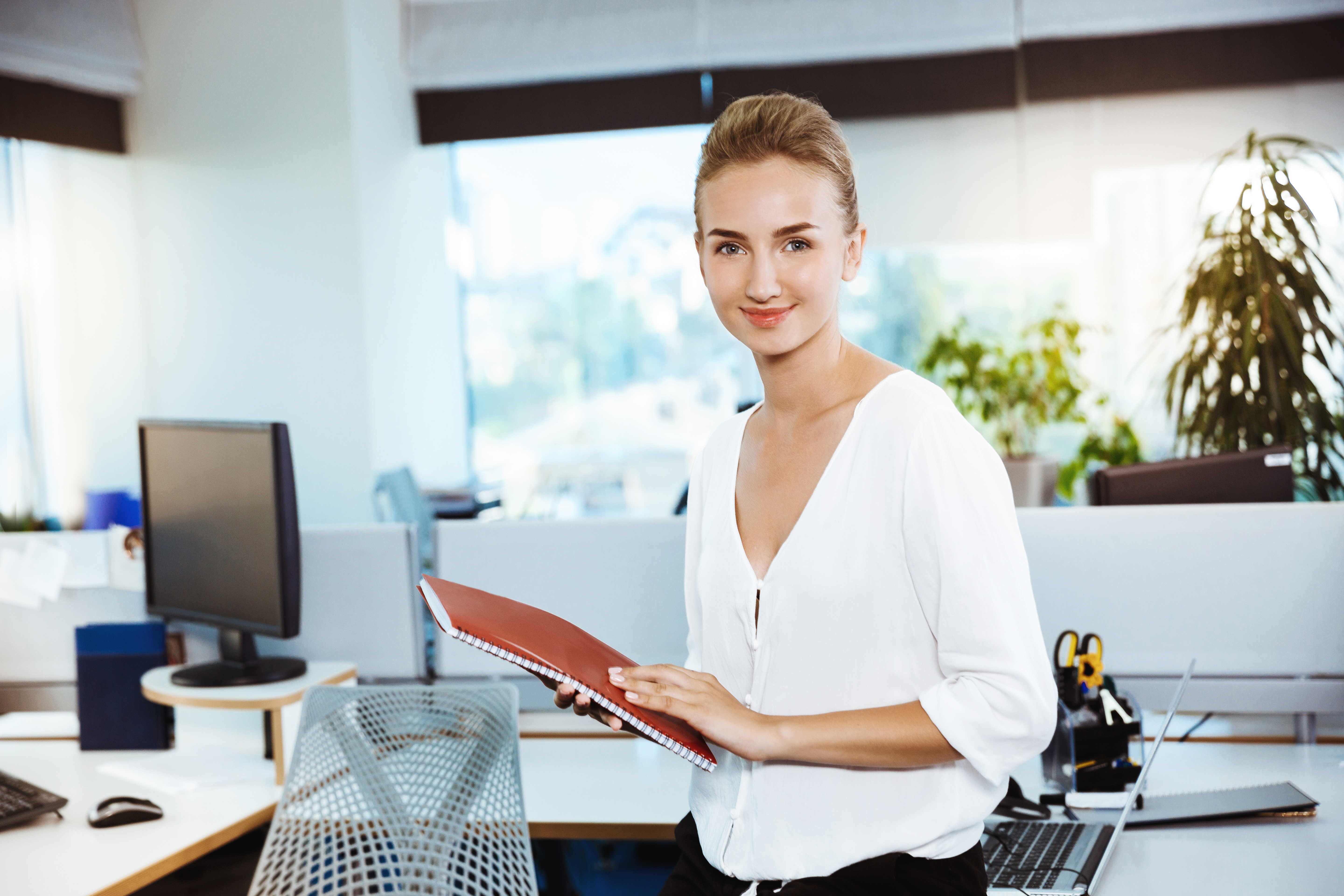 young-beautiful-successful-businesswoman-smiling-posing-holding-folder-office.jpg