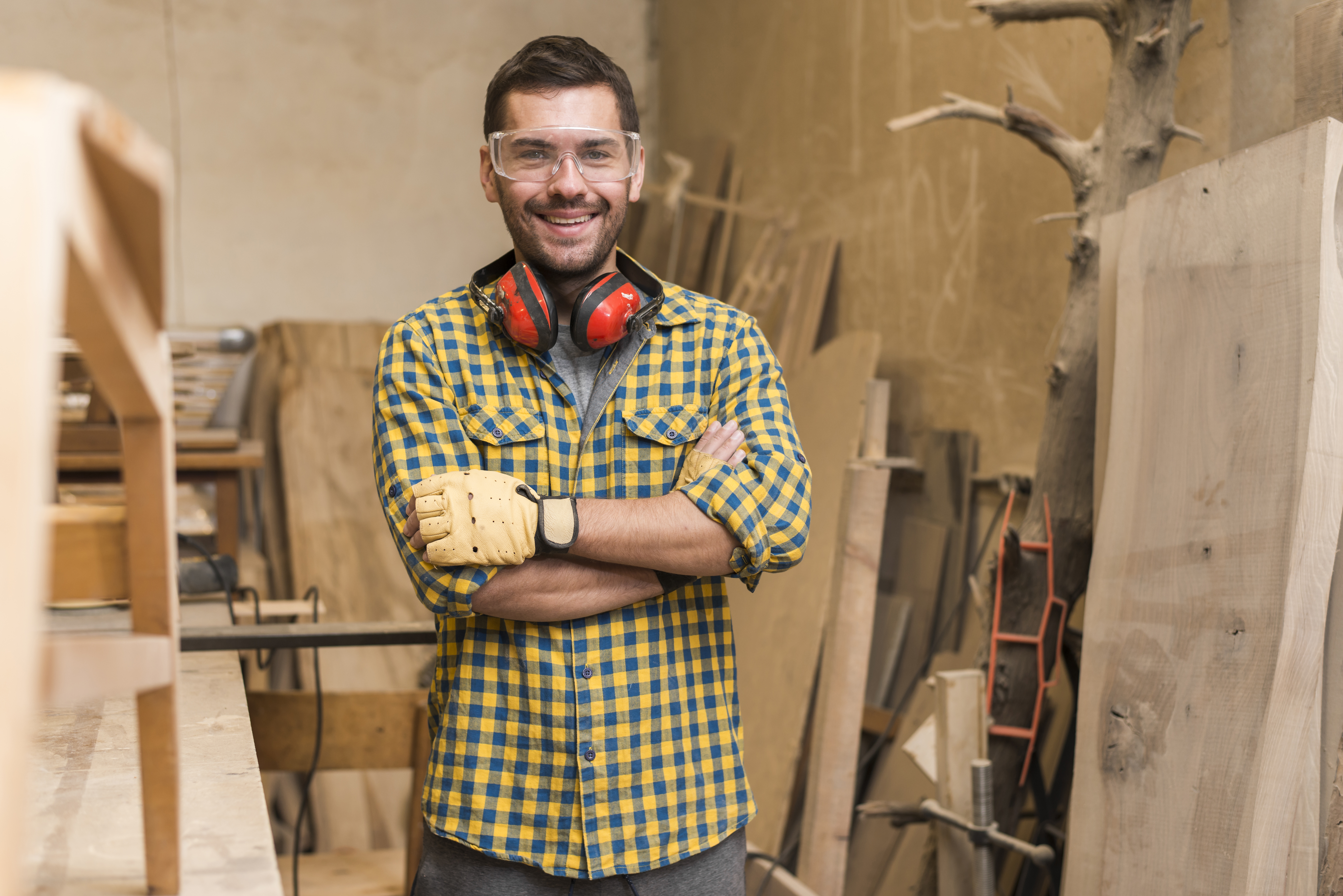 confident-happy-carpenter-with-his-arm-crossed-standing-workshop.jpg