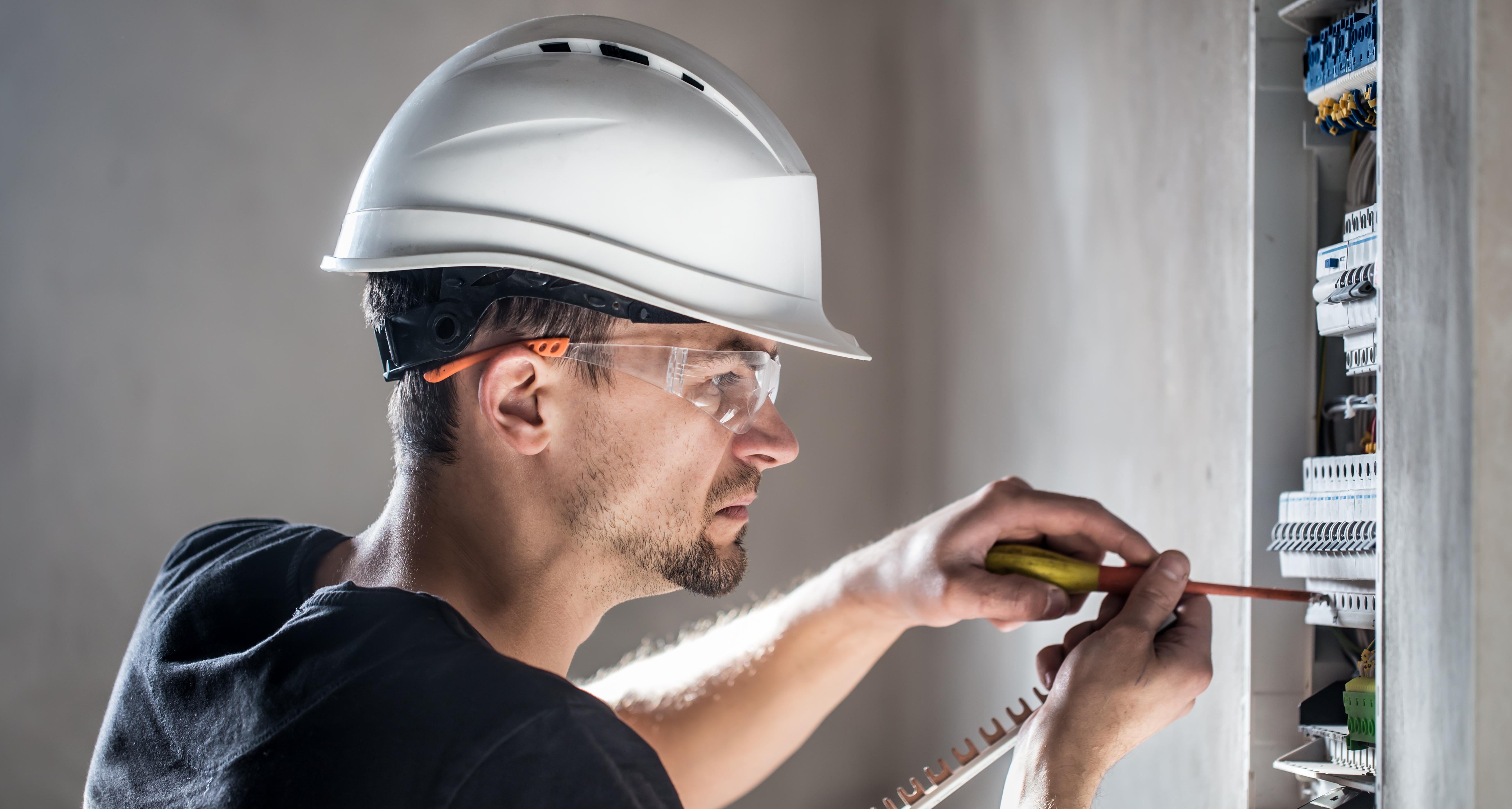 electrical-technician-working-switchboard-with-fuses-installation-connection-electrical-equipment.jpg
