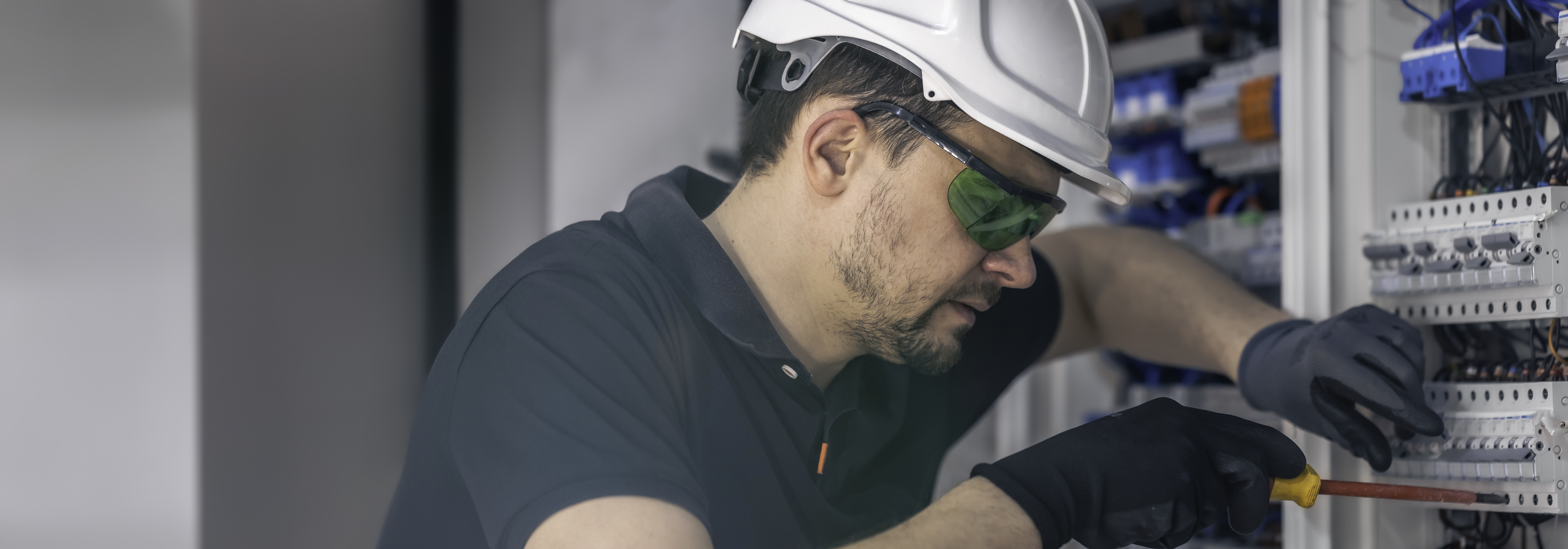 male-electrician-works-switchboard-using-electrical-connection-cable.jpg