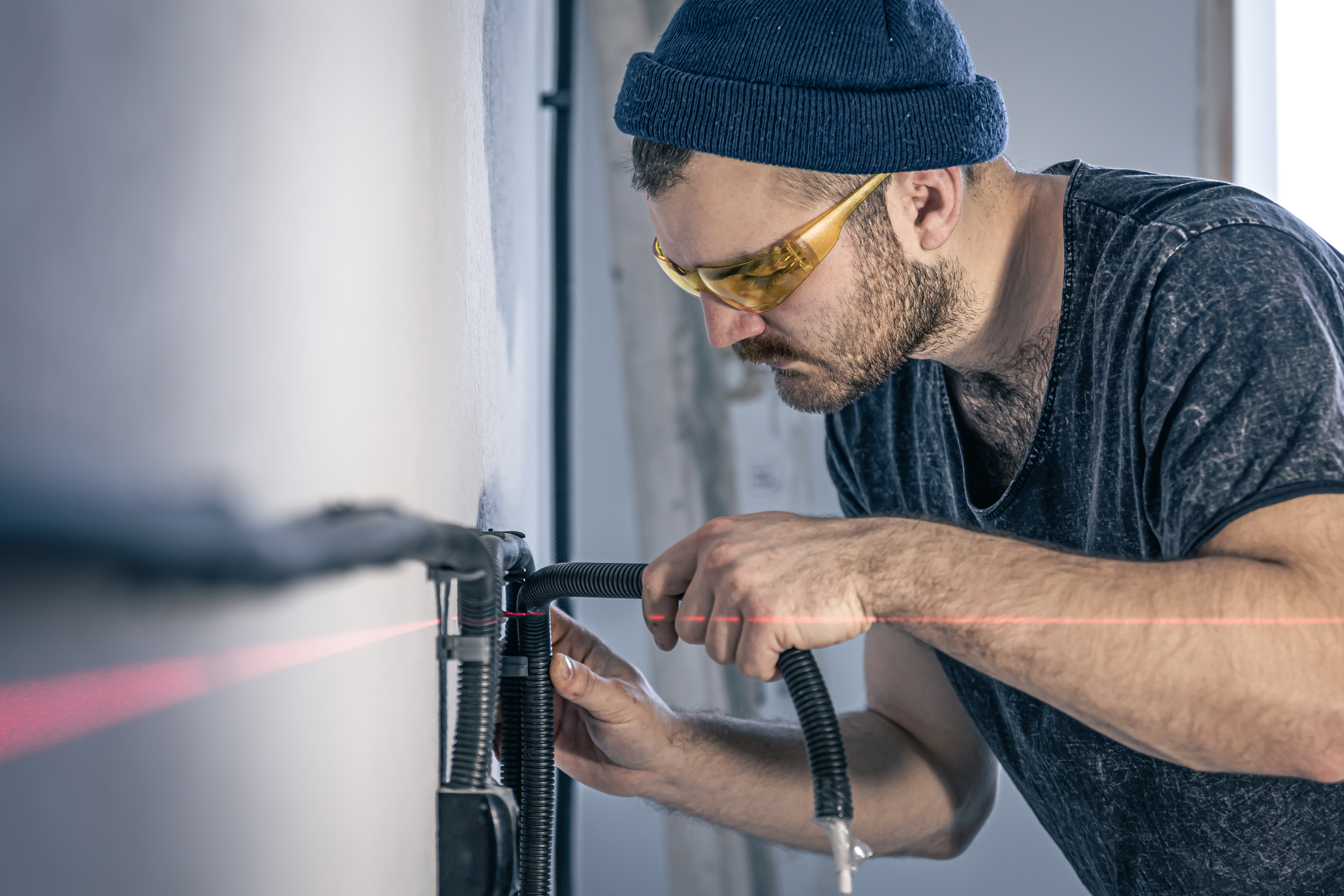 electrician-is-mounting-electric-sockets-white-wall-indoors.jpg