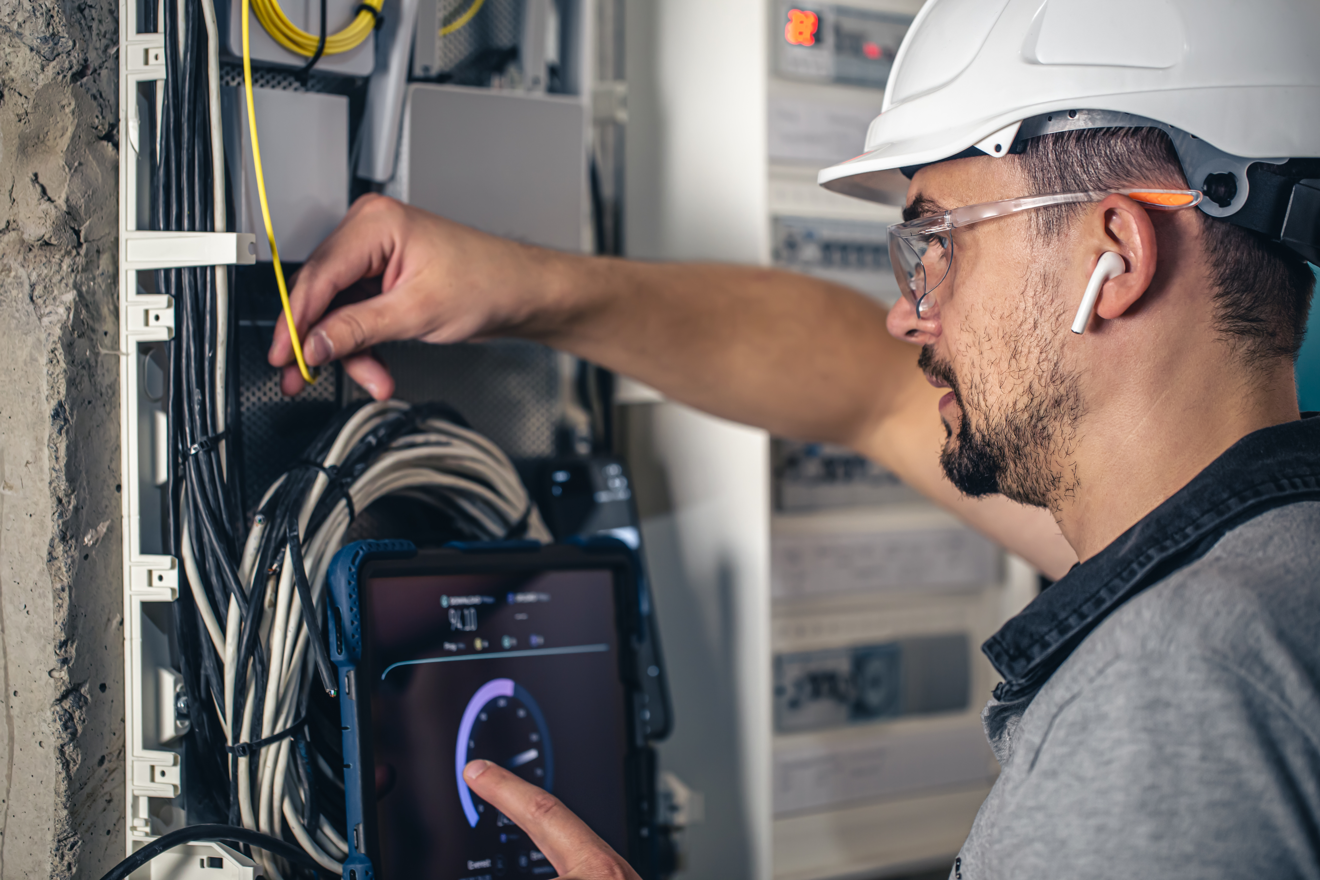 man-electrical-technician-working-switchboard-with-fuses.jpg