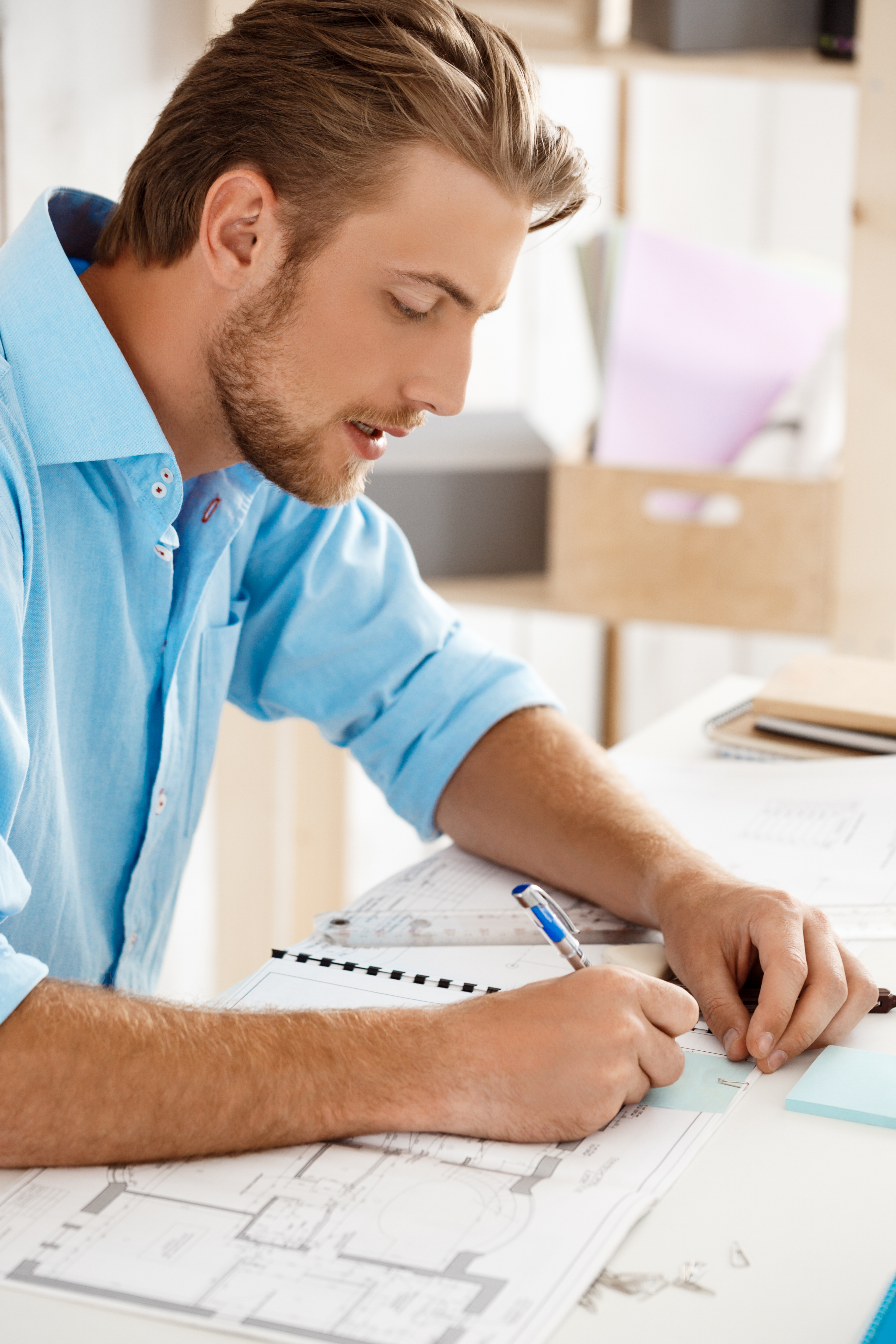 young-handsome-confident-pensive-businessman-working-sitting-table-writing-notebook-white-modern-office-interior.jpg