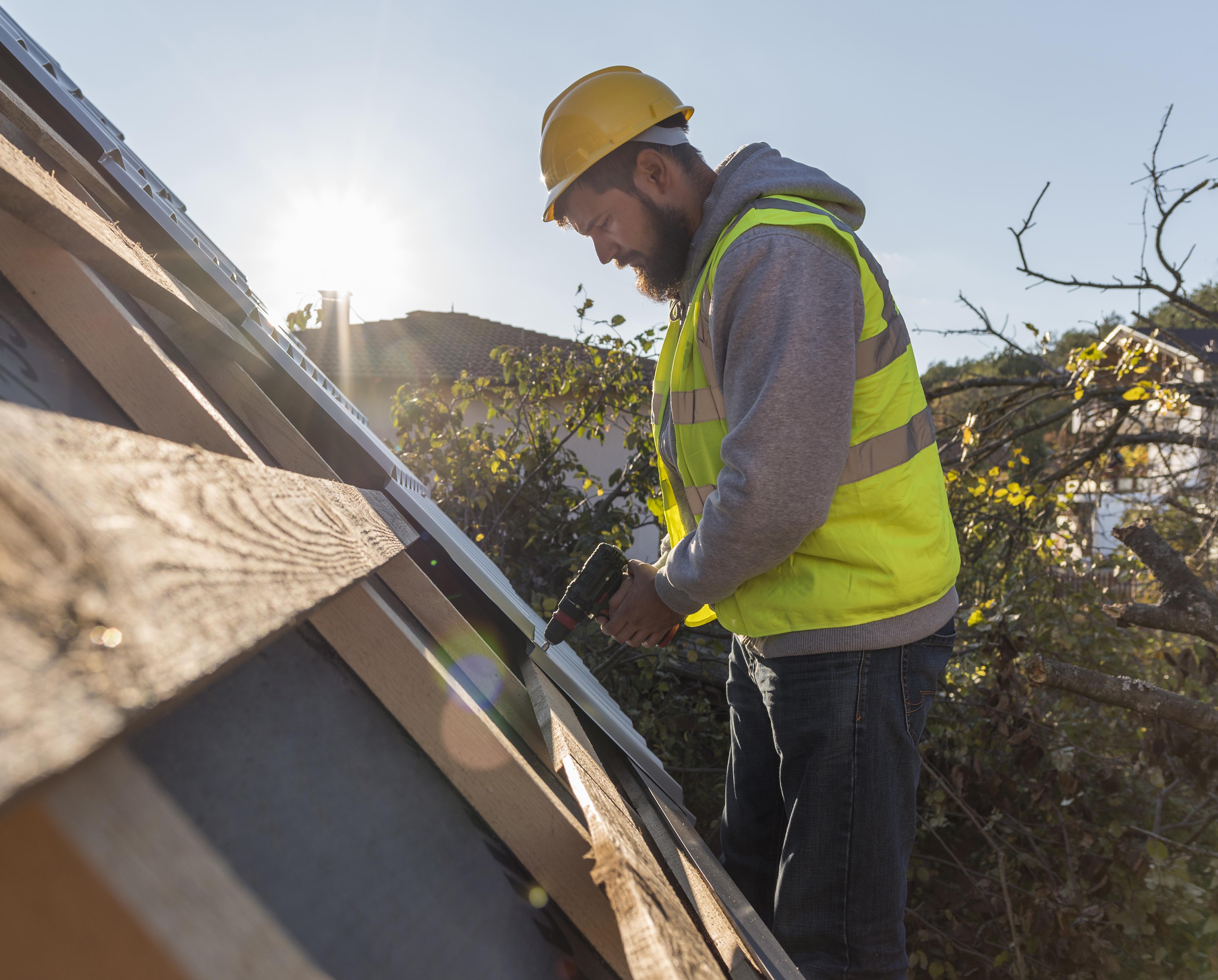 man-working-roof-with-drill.jpg