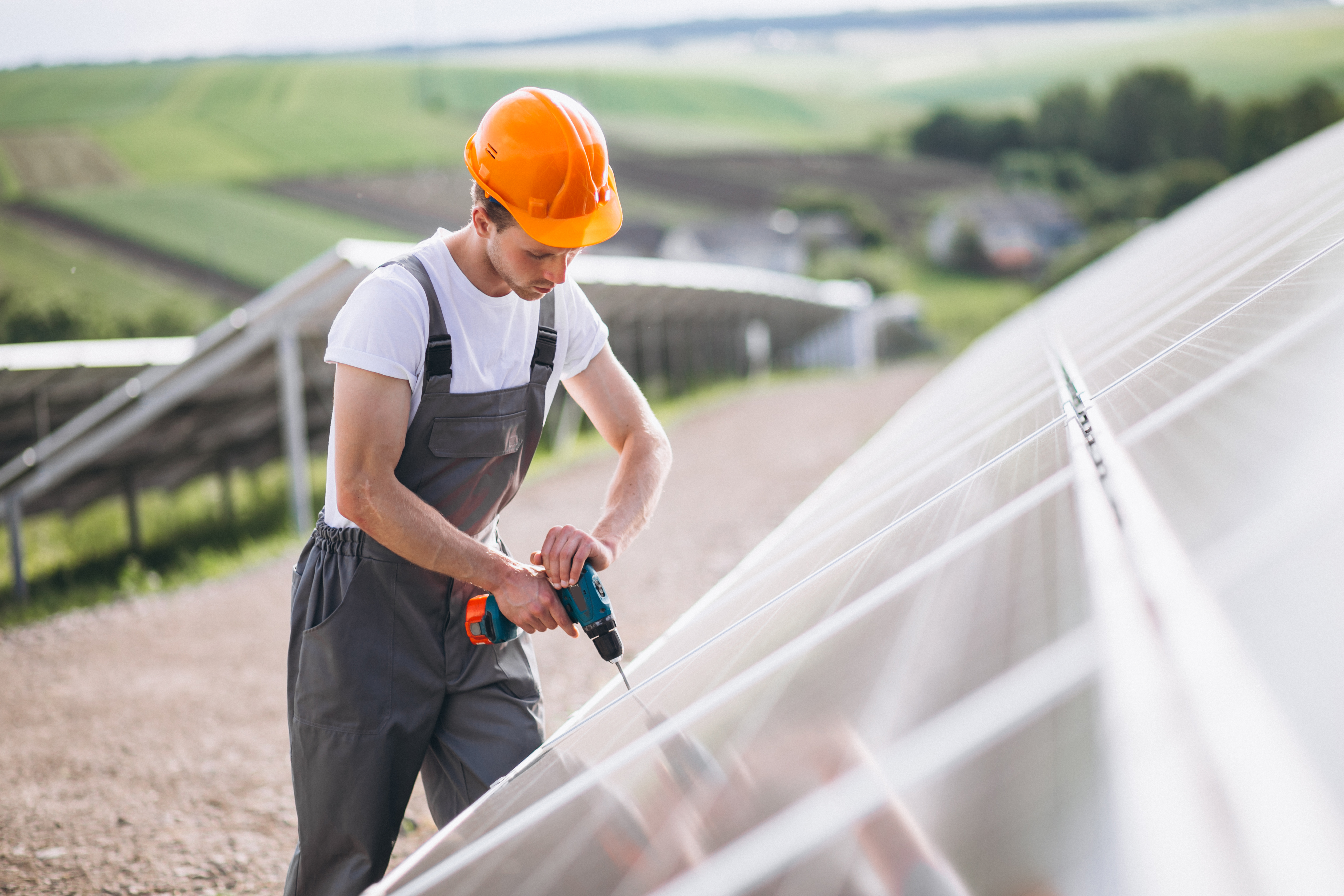 man-worker-firld-by-solar-panels.jpg