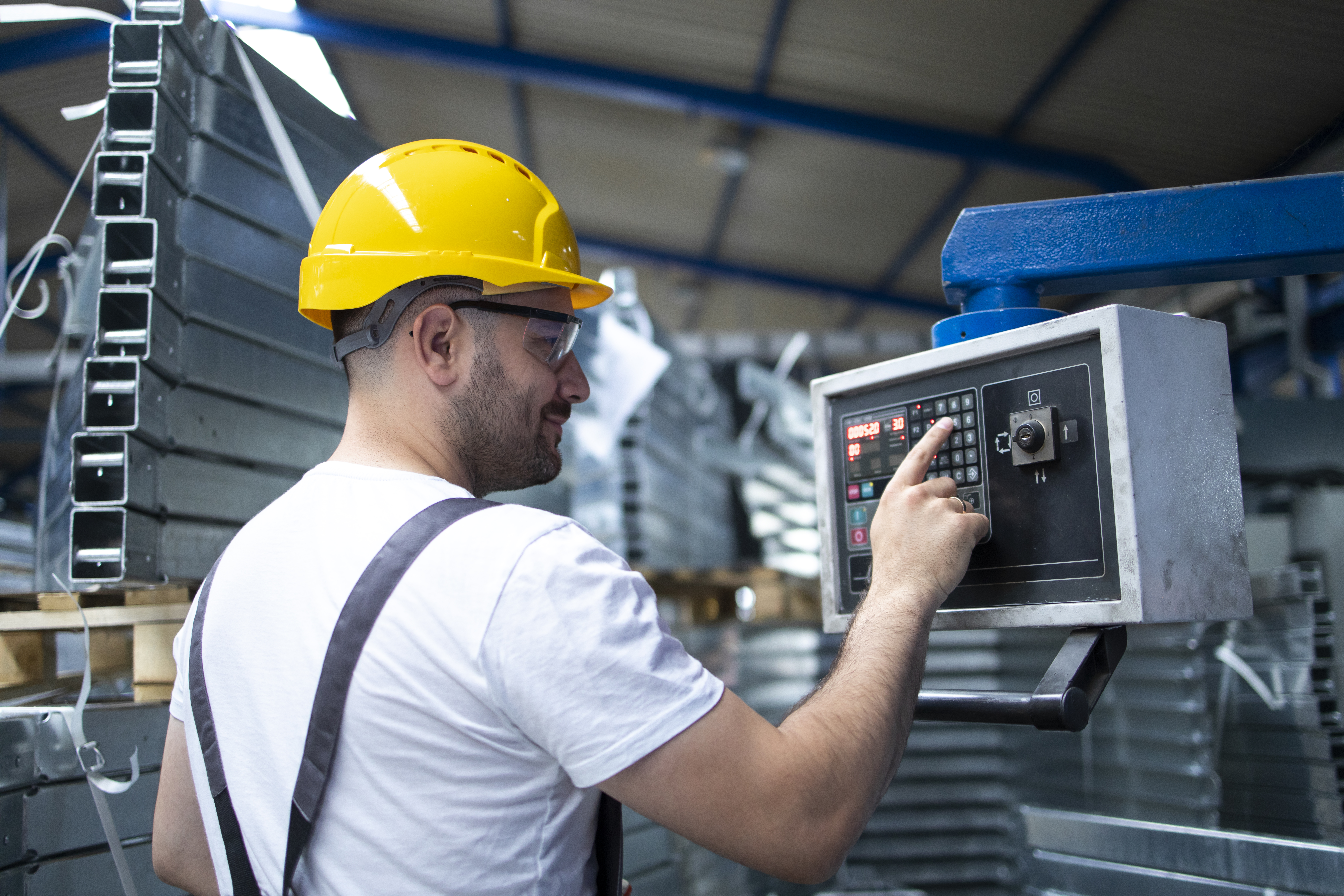 factory-worker-operating-industrial-machine-setting-parameters-computer.jpg