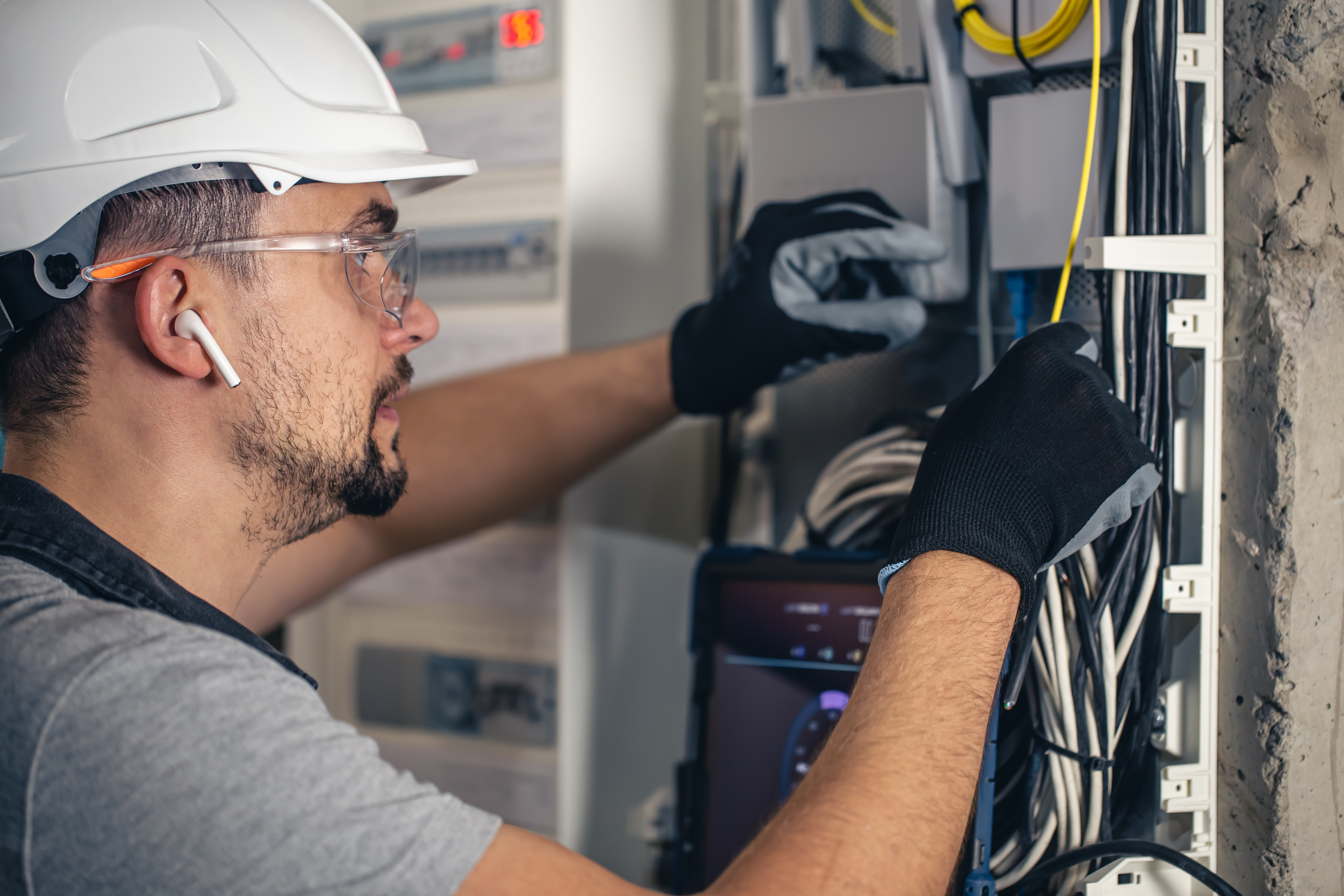 man-electrical-technician-working-switchboard-with-fuses.jpg