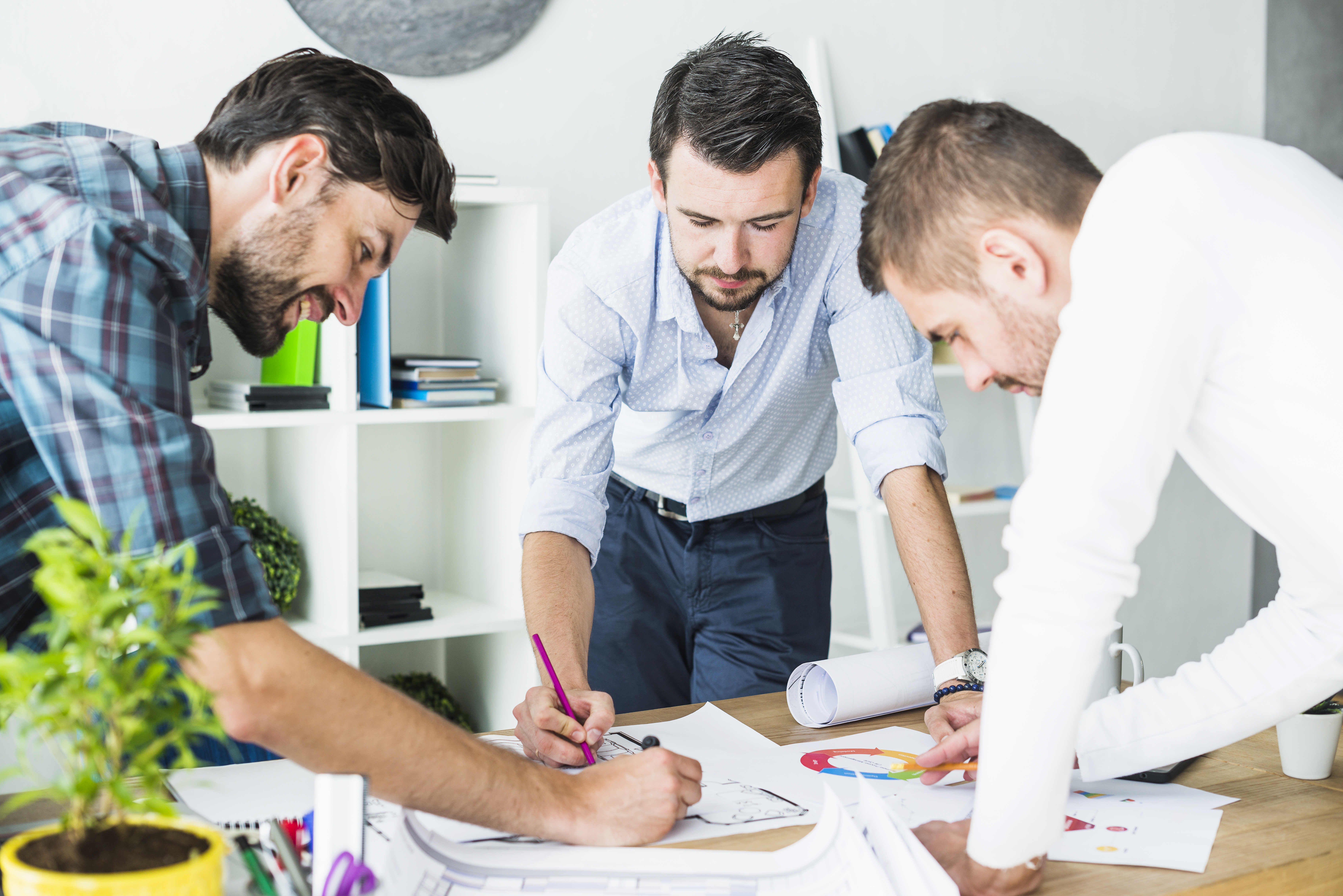 group-male-architect-planning-blueprint-wooden-desk.jpg