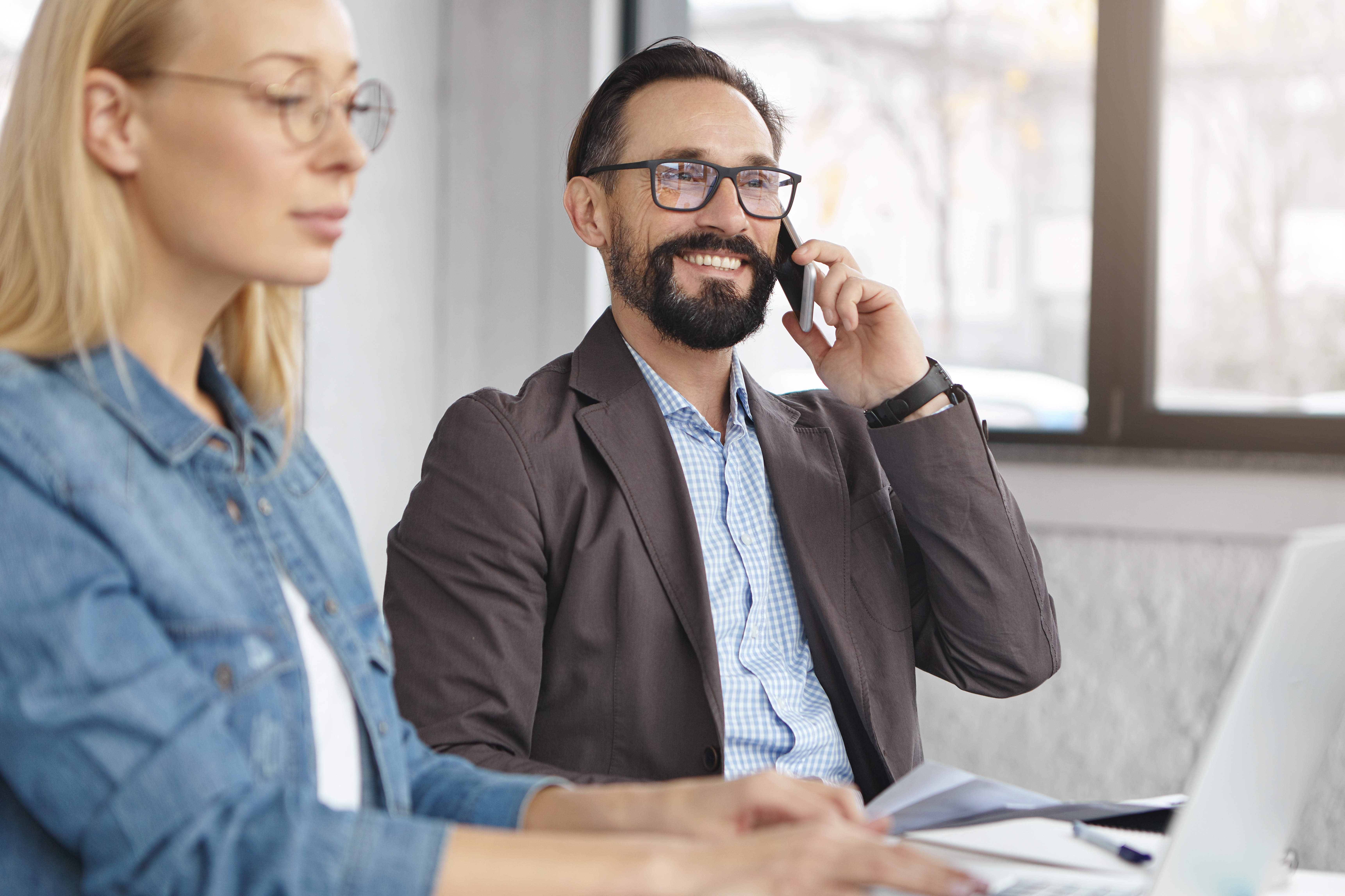 happy-blonde-female-manager-has-conversation-with-male-colleague.jpg