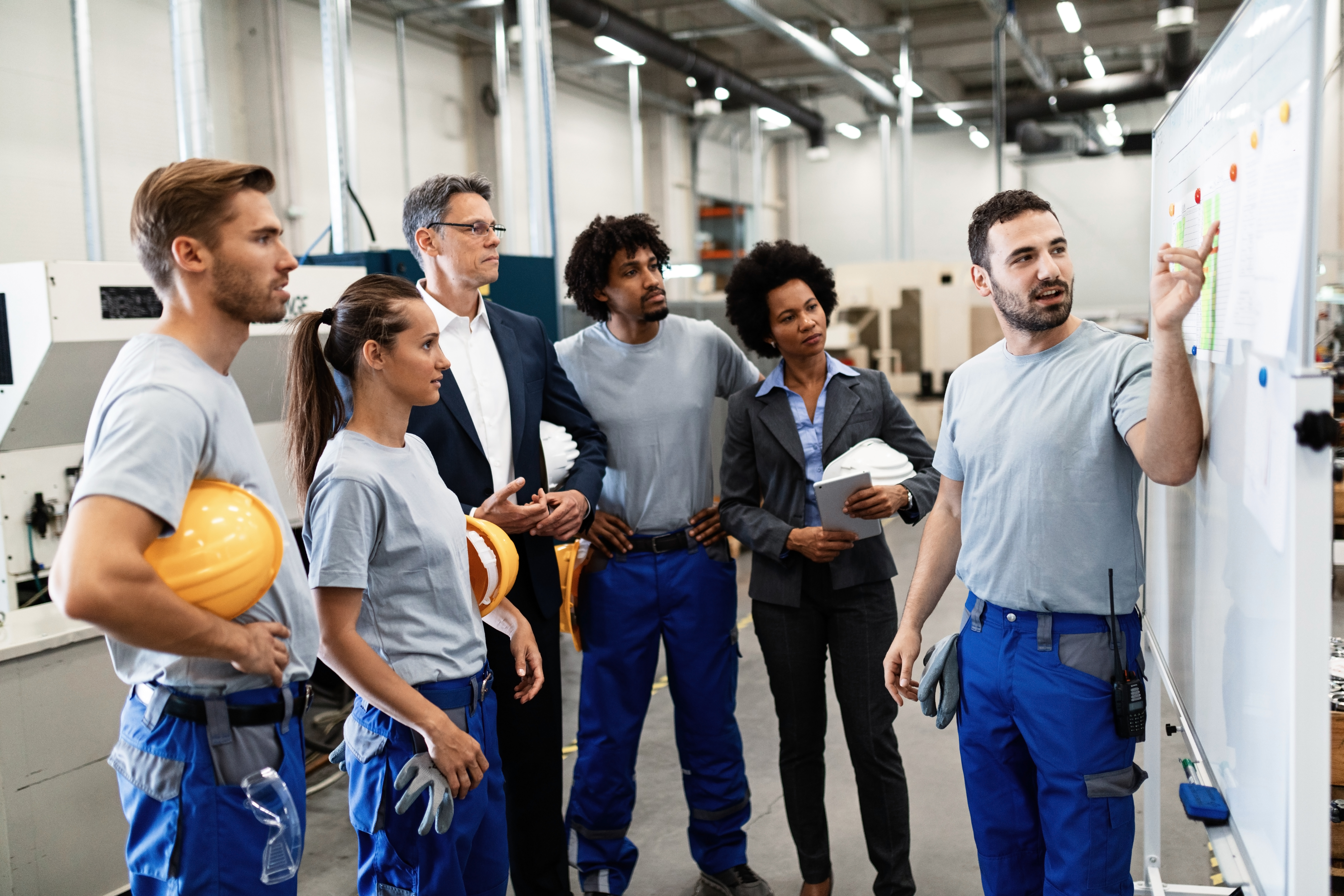 happy-manual-worker-presenting-results-business-development-while-giving-presentation-company-leaders-his-team-factory.jpg