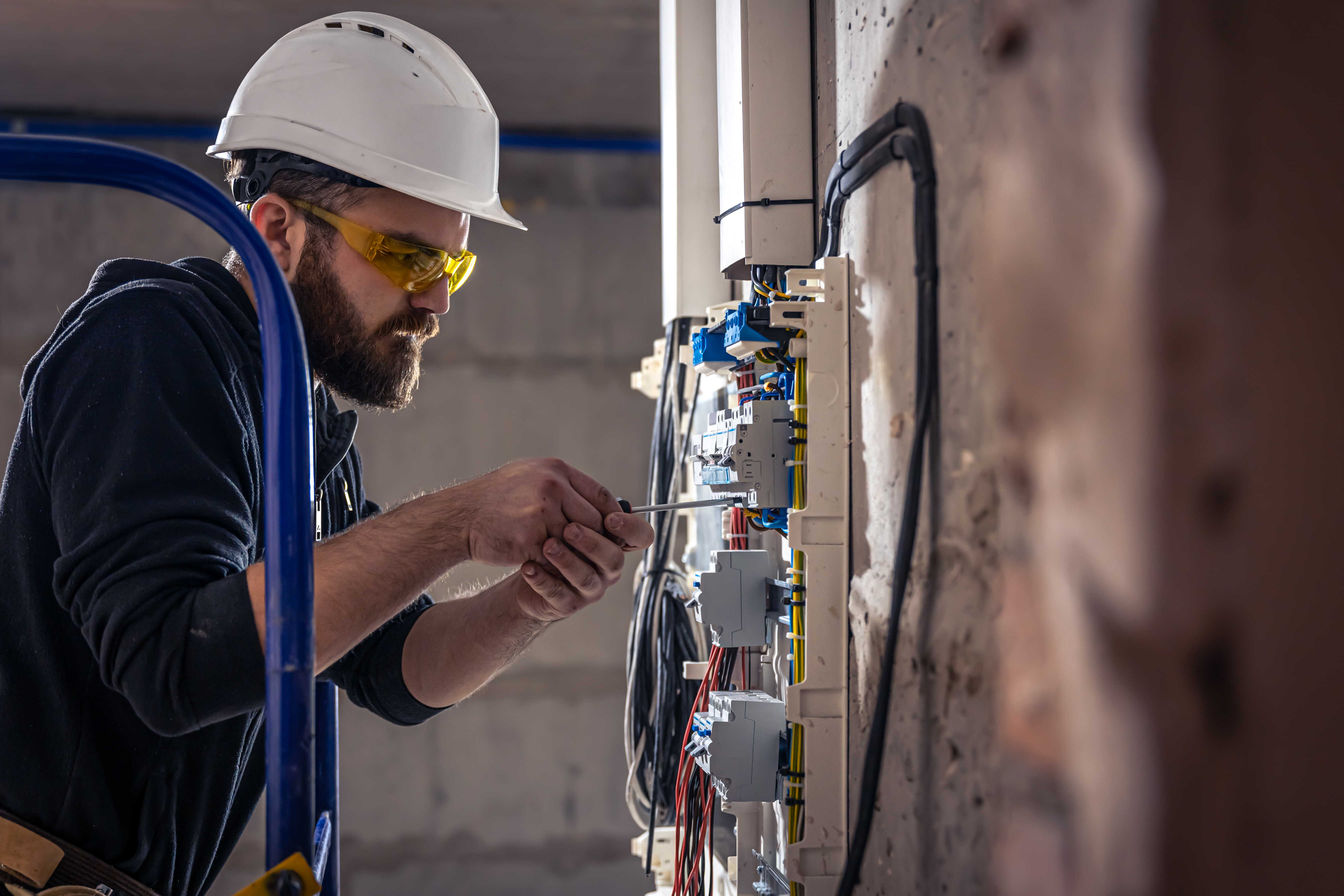 male-electrician-works-switchboard-with-electrical-connecting-cable.jpg