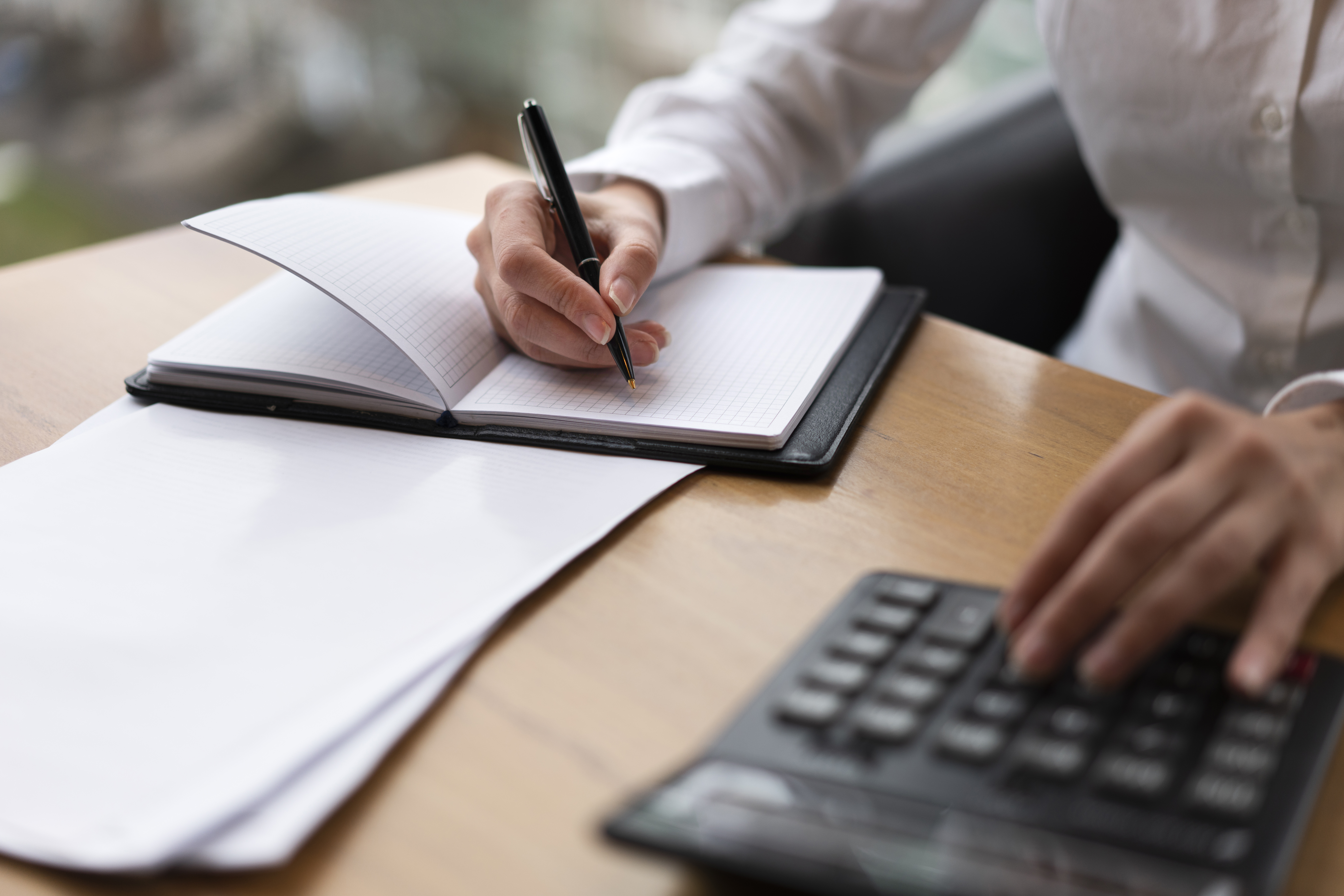 corporate-woman-calculating-writing.jpg