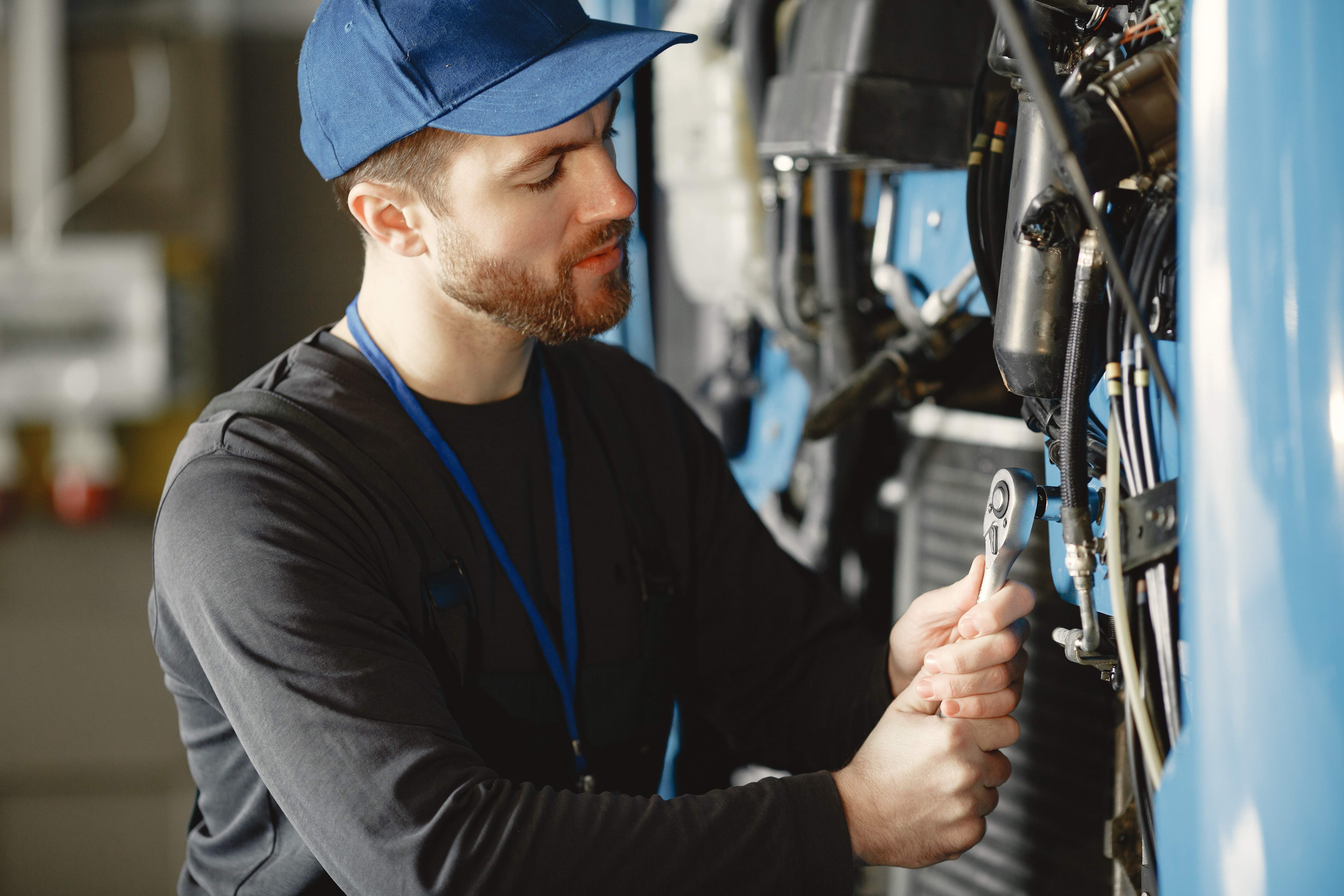 car-mechanic-repairs-blue-car-garage-with-tools.jpg