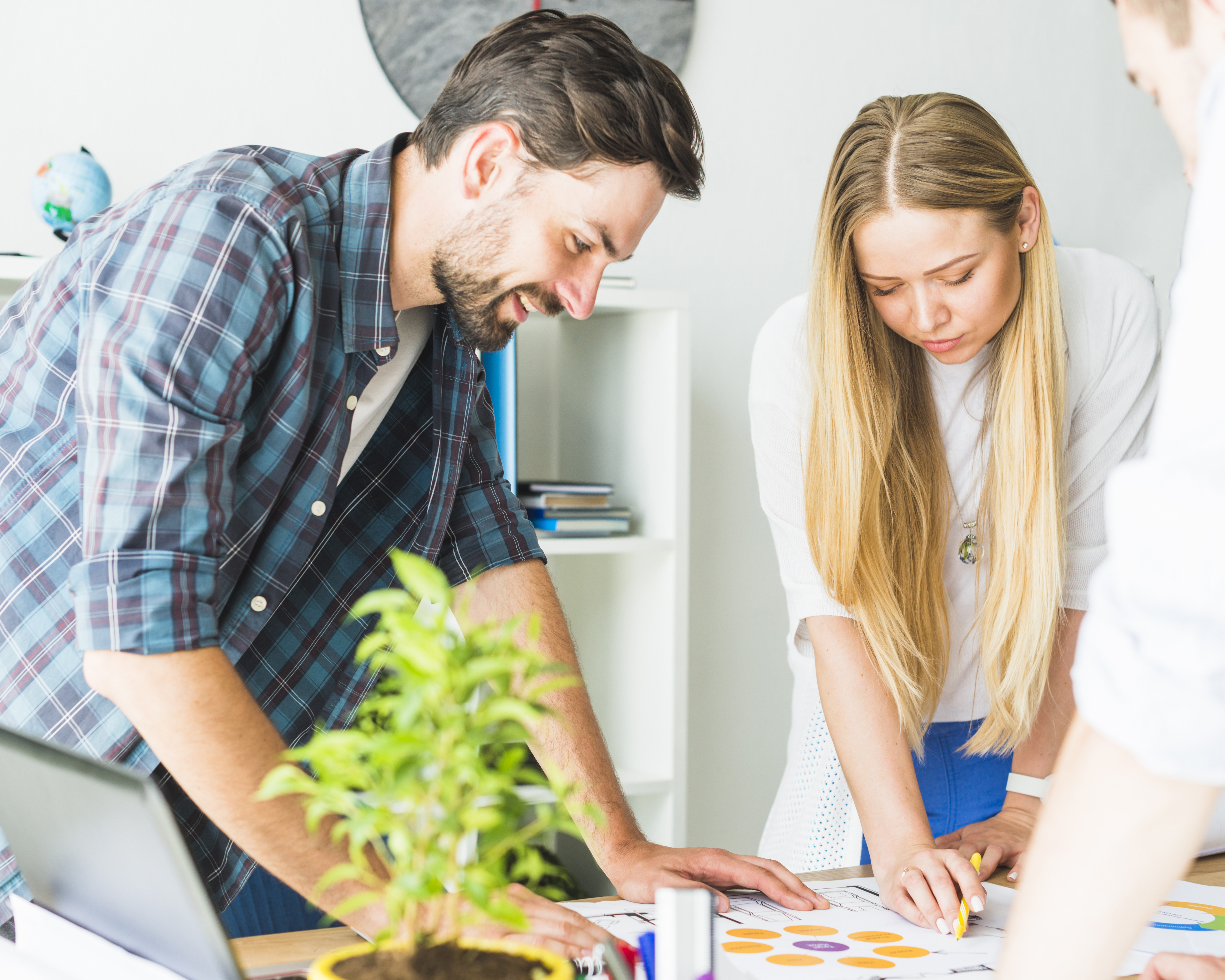 two-young-businesspeople-looking-graph-desk.jpg