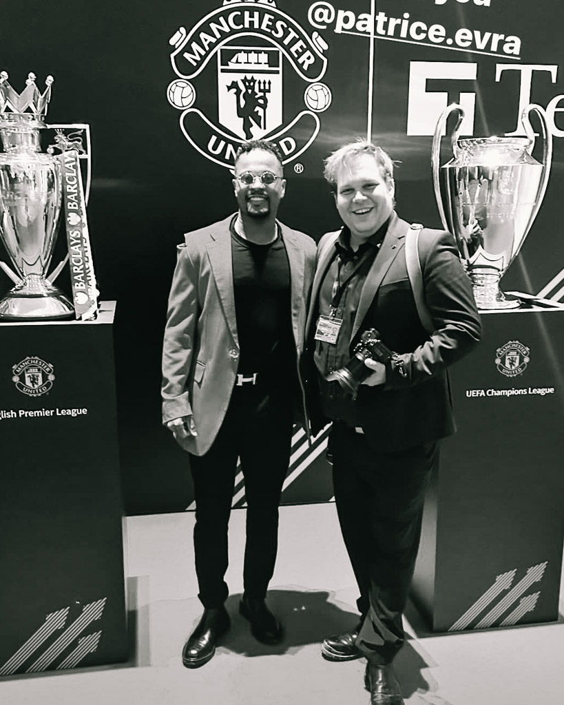 Robin Kirchhofer mit Patrice Evra vor den Pokalen von Manchester United