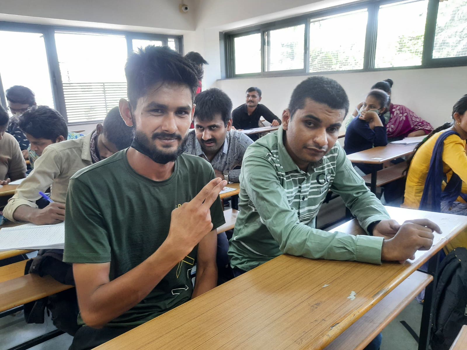 UUF volunteers supporting students at a writing workshop