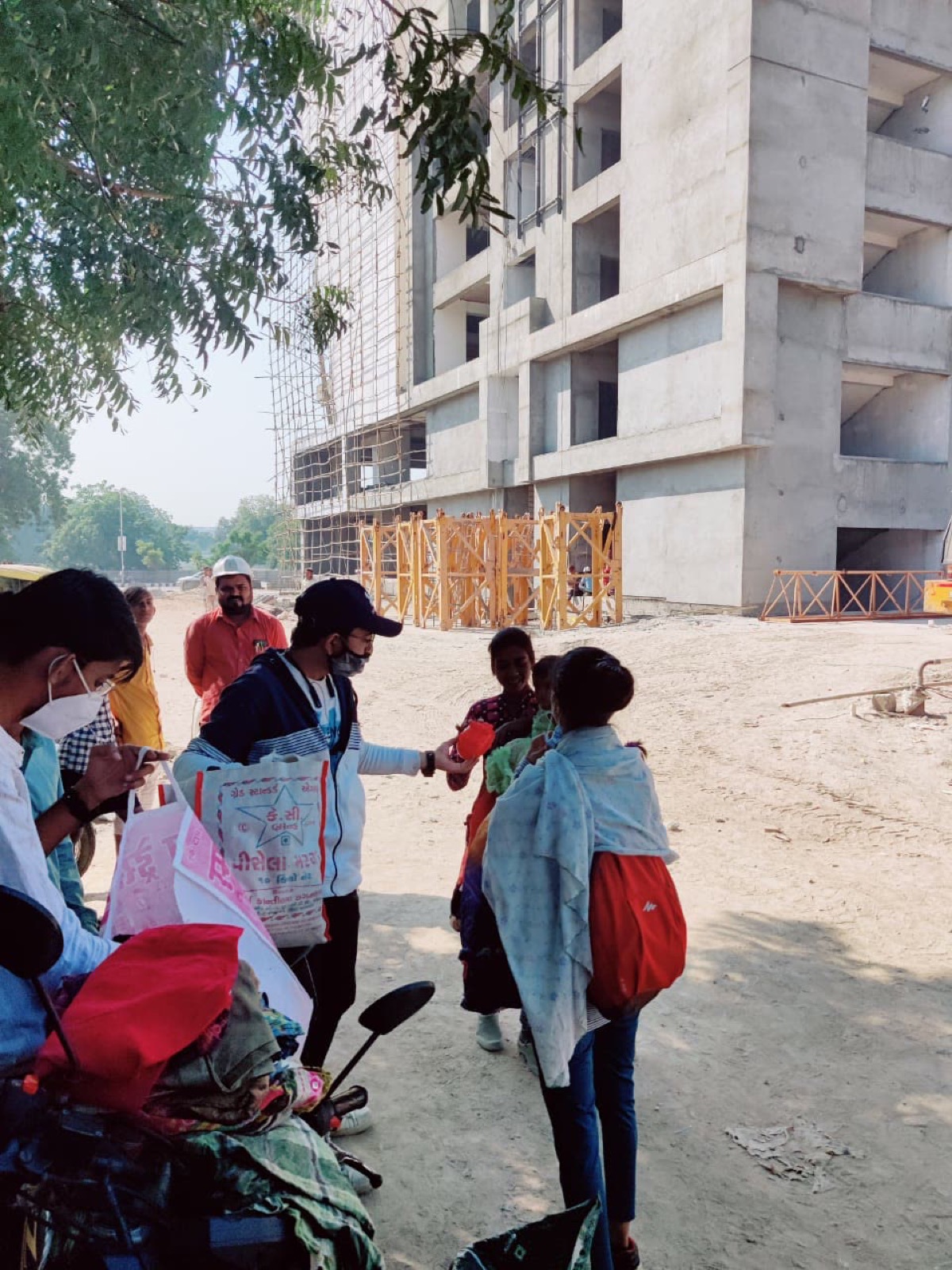 A UUF volunteer handing clothing to a community member