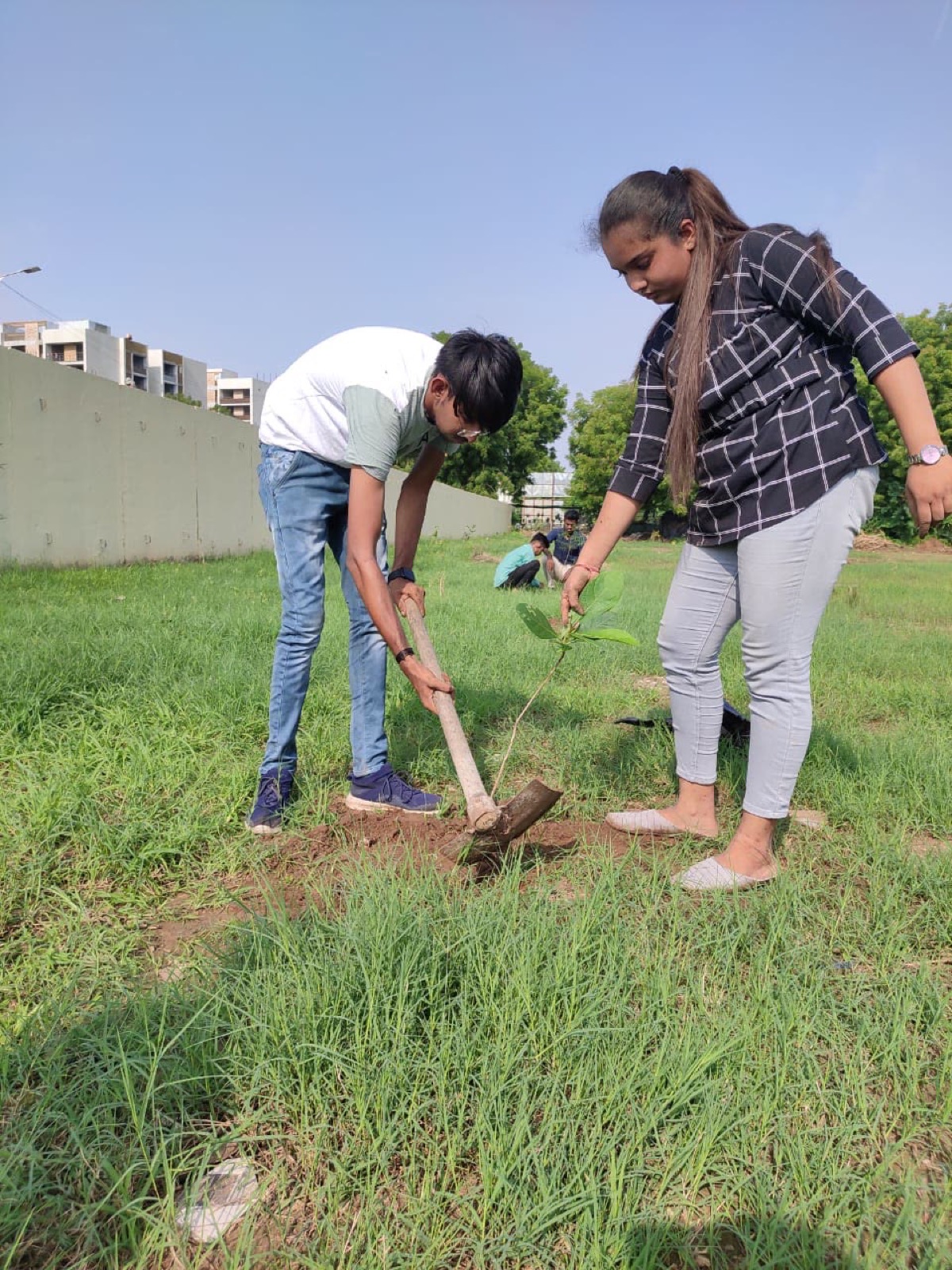 A UUF volunteer planting a sapling during the plantation drive