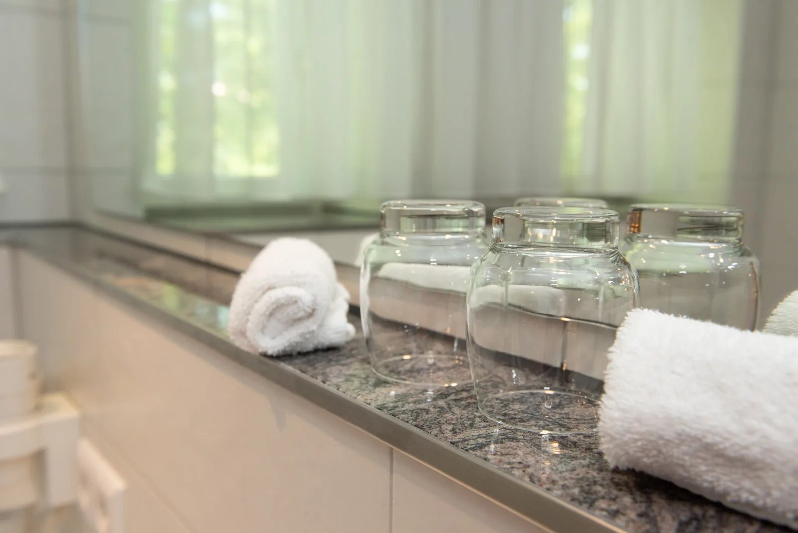 Handtücher und Wassergläser auf der Ablage im Badezimmer