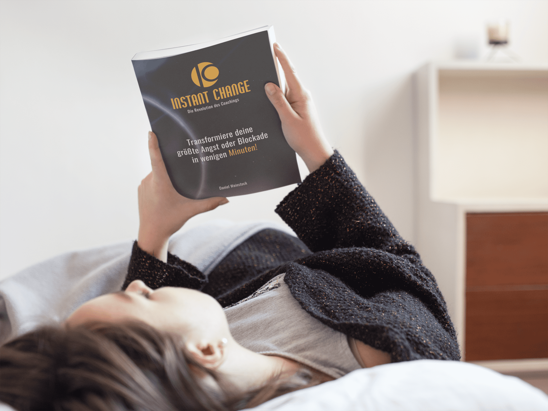 young-girl-looking-at-a-book-cover-while-lying-down-in-her-bed-mockup-a14302(1).png