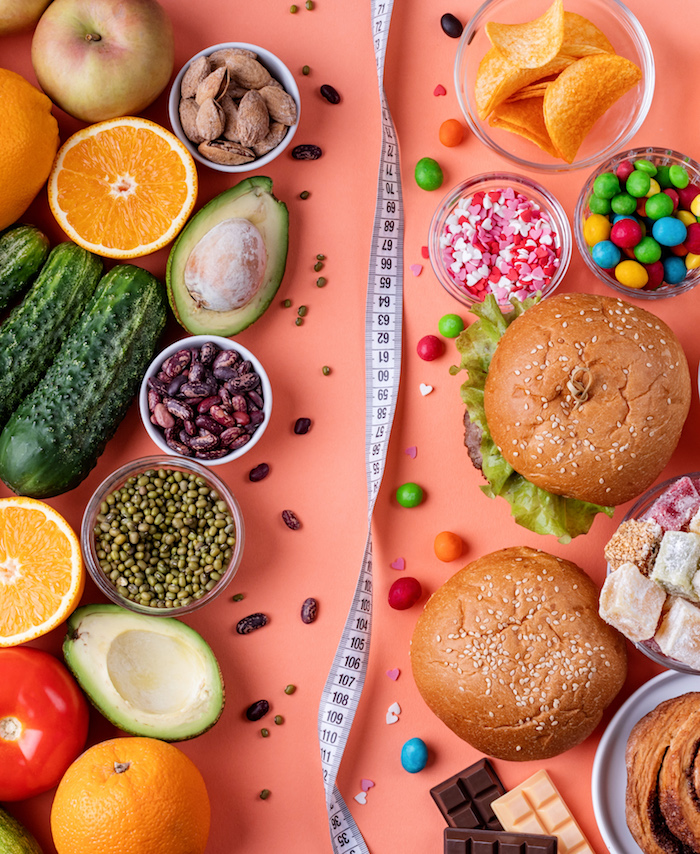 gesunde und ungesunde Lebensmittel Vergleich mit Maßband Trennung auf farbigem Hintergrund
