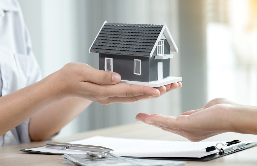 hand-a-real-estate-agent-hold-the-home-model-and-explain-the-business-contract-rent-buy-mortgage-loan-or-home-insurance-to-the-buyer-woman.jpg